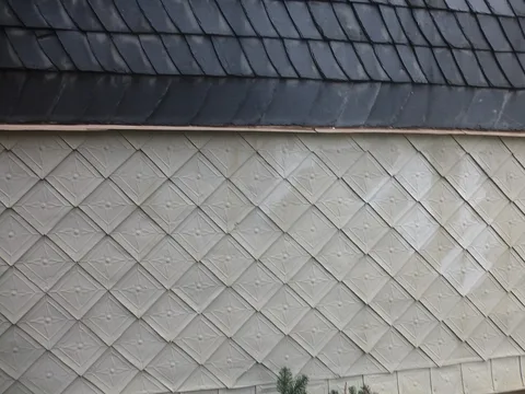 Façade contemporaine habillée d'écailles métalliques posées en losange